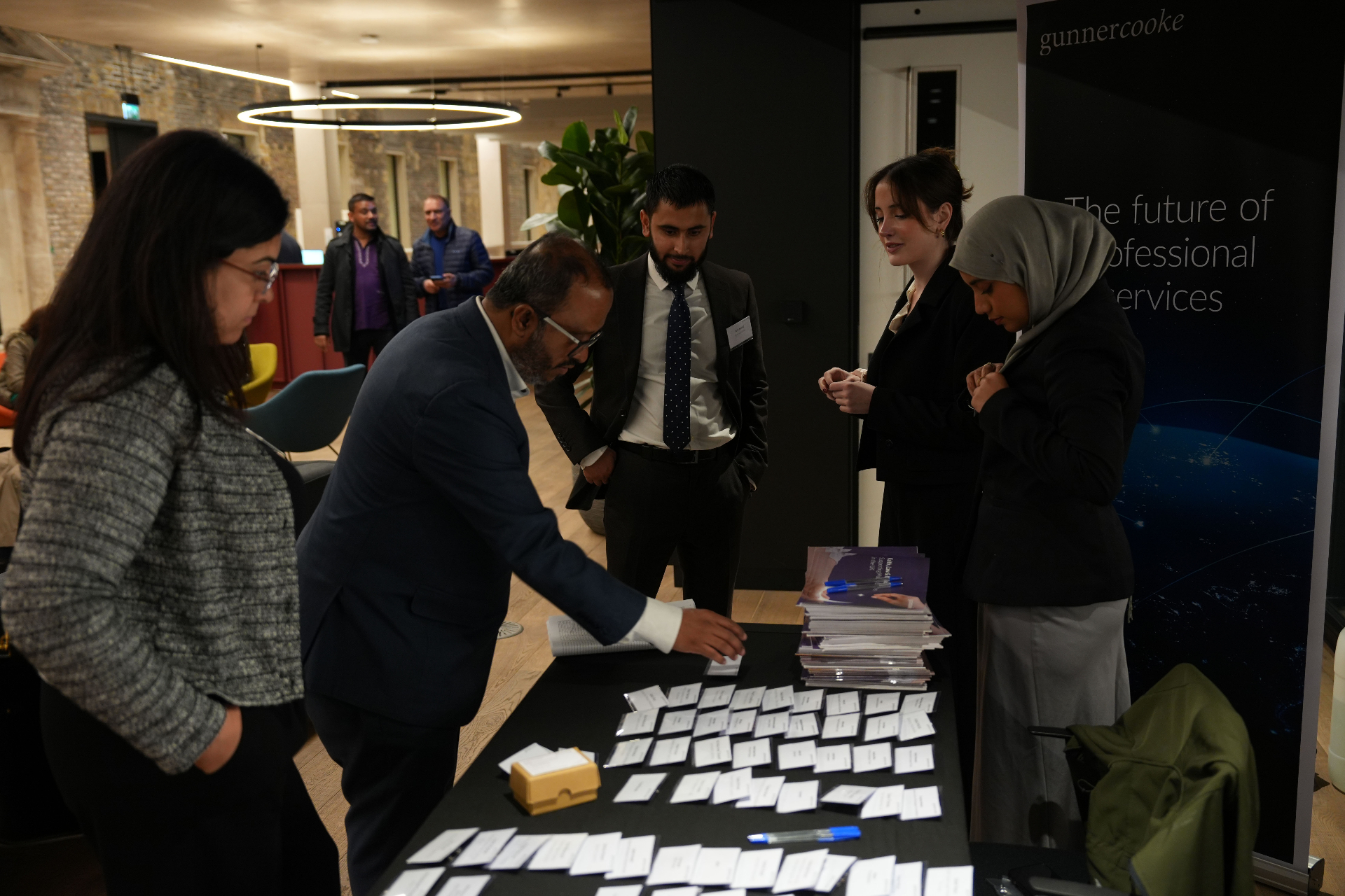 Attendees registering at a gunnercooke charity seminar